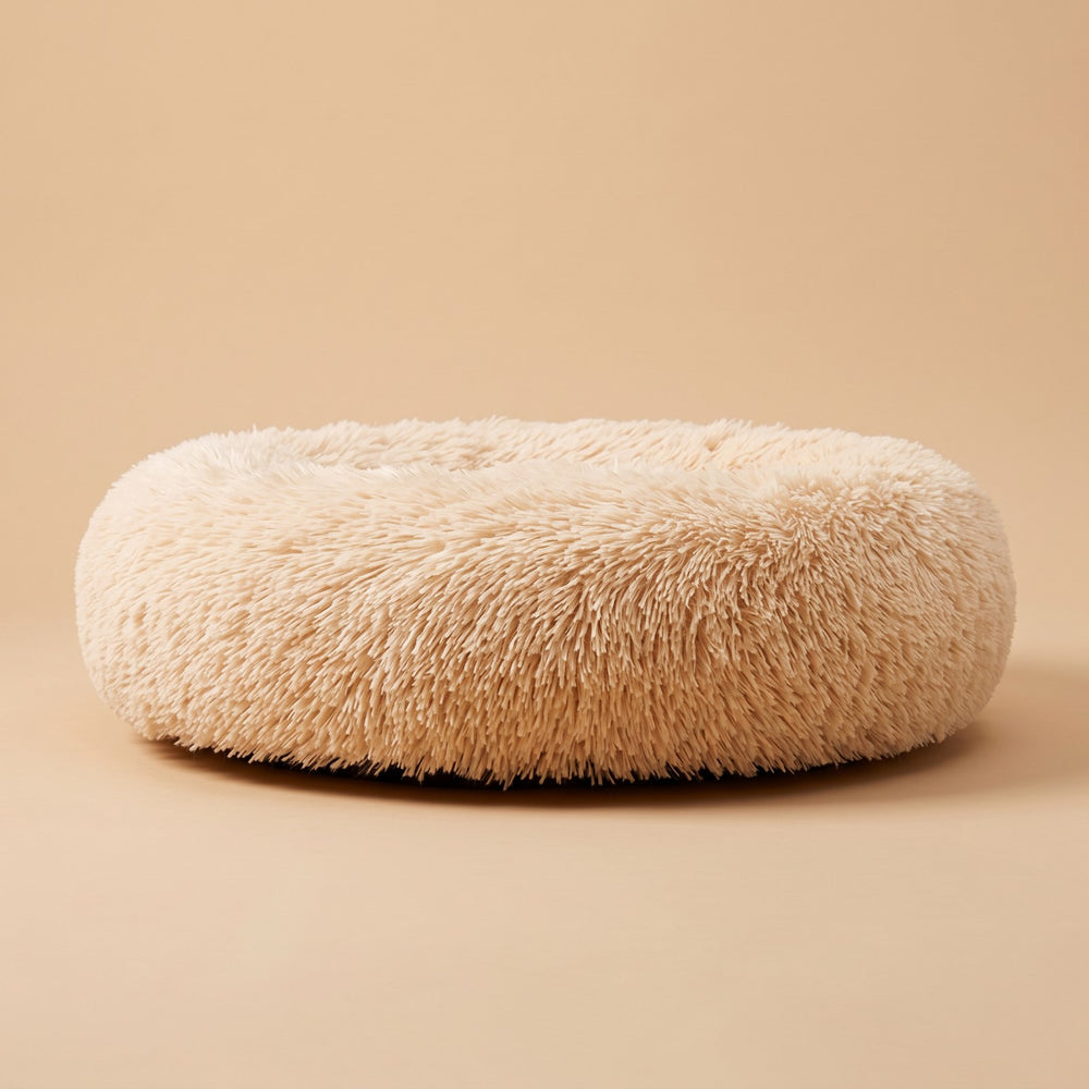 Side view of the Cozy Nest bed showing its raised plush rim