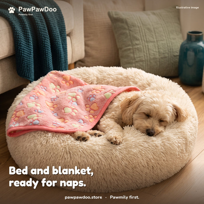 Small dog asleep in a Cozy Nest bed with a pink paw-print blanket over its back