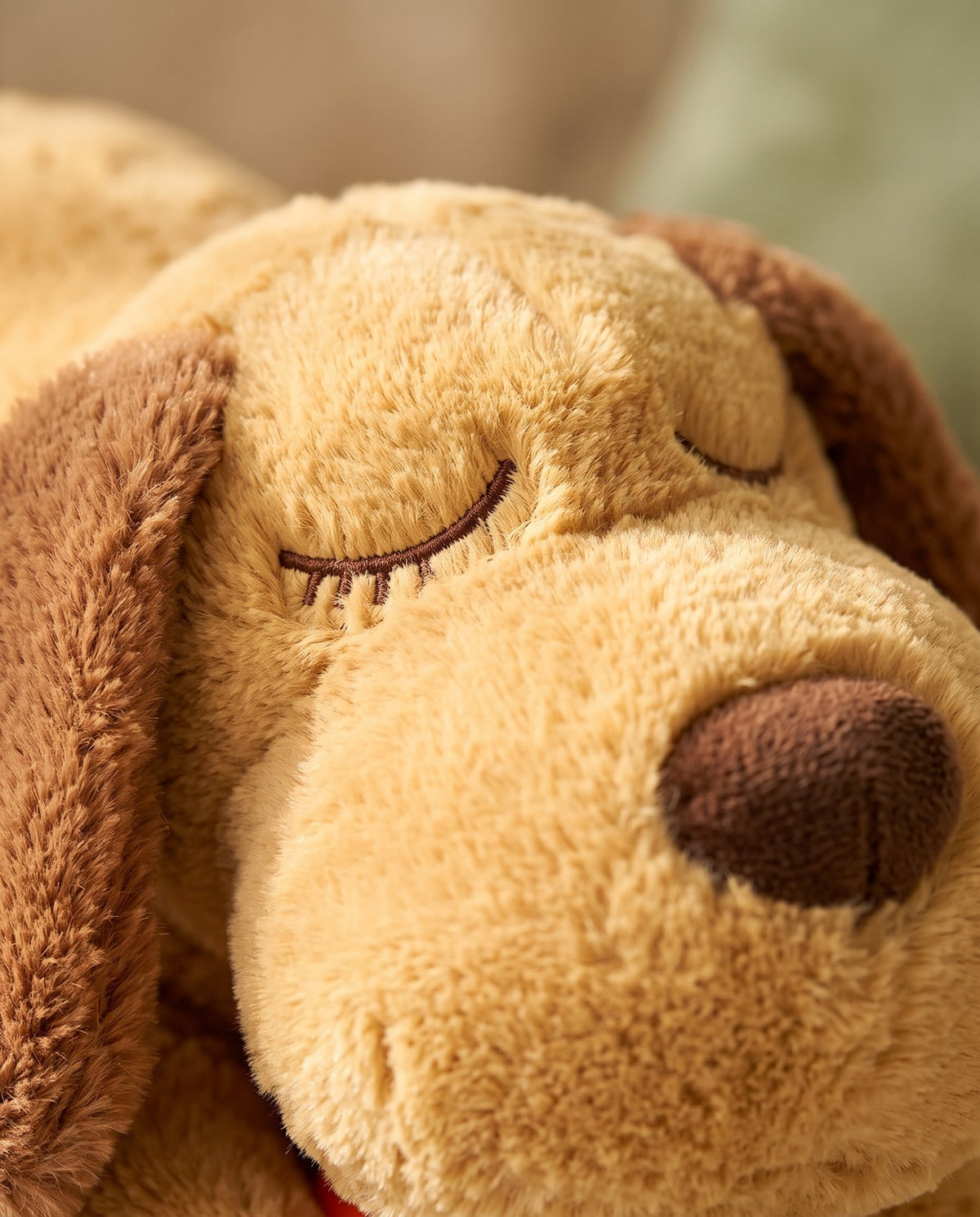 Close-up of the Heartbeat Comfort Plush soft fur and stitched closed eyes